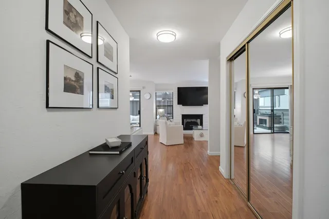 a kitchen with granite countertop a stove and a wooden floor