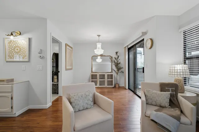 a living room with furniture and a chandelier