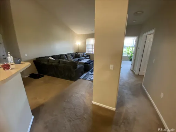 a living room with furniture and a mirror