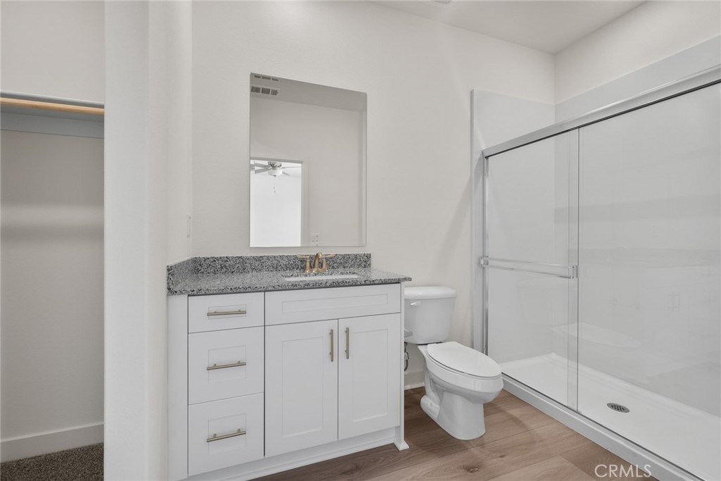14812 Indigo Street Apple Valley, CA 92307 - Photo 7 of 7 a bathroom with a granite countertop sink a toilet and shower