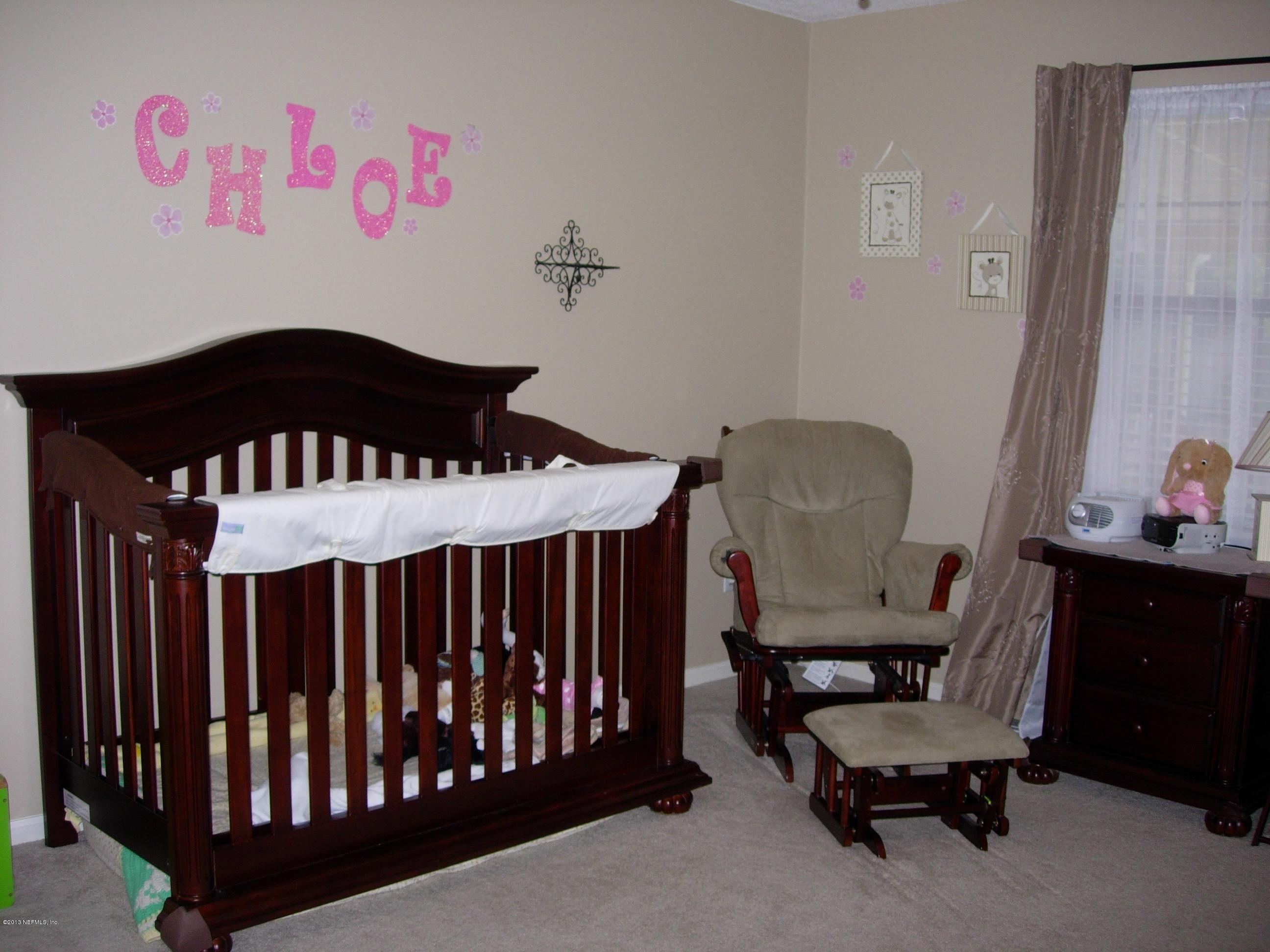 11060 Reading Road Jacksonville, FL 32257 - Photo 17 of 31 a bedroom with a bed and wooden floor