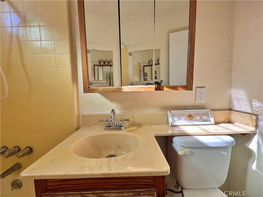 1852 260th Street Lomita, CA 90717 - Photo 30 of 63 a bathroom with a sink and a mirror