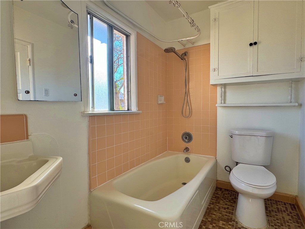 1852 260th Street Lomita, CA 90717 - Photo 53 of 63 a bathroom with a white bath tub a toilet and a sink