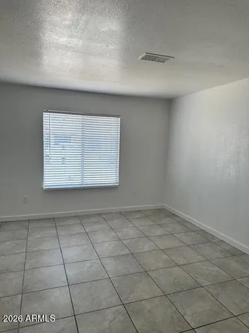 a view of an empty room and a window