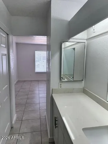 a bathroom with a granite countertop sink a toilet and mirror