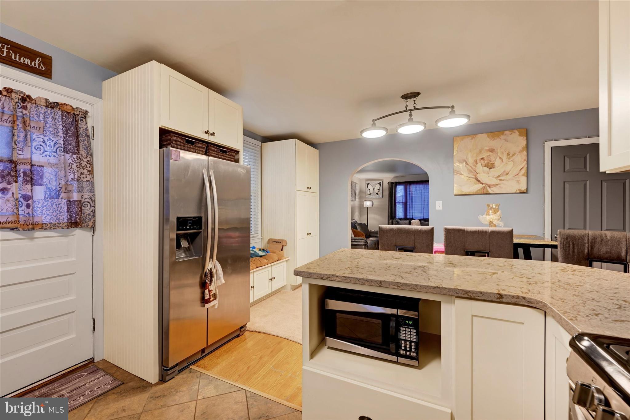 1813 Hanford Road Rosedale, MD 21237 - Photo 11 of 39 a kitchen with stainless steel appliances granite countertop a refrigerator and a stove top oven
