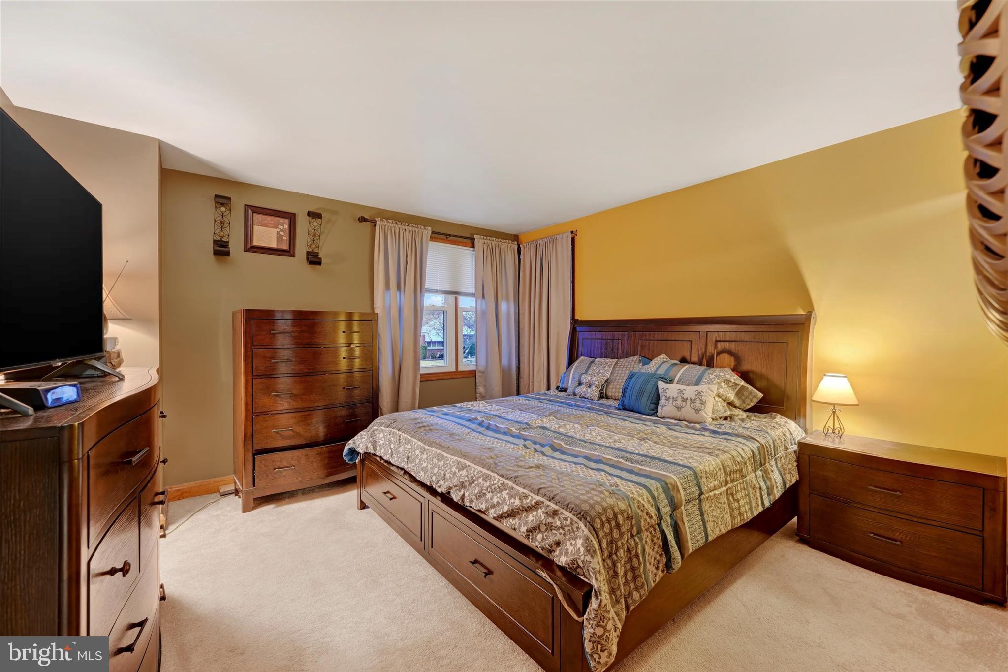 1813 Hanford Road Rosedale, MD 21237 - Photo 12 of 39 a bedroom with a bed and a flat tv screen on dresser
