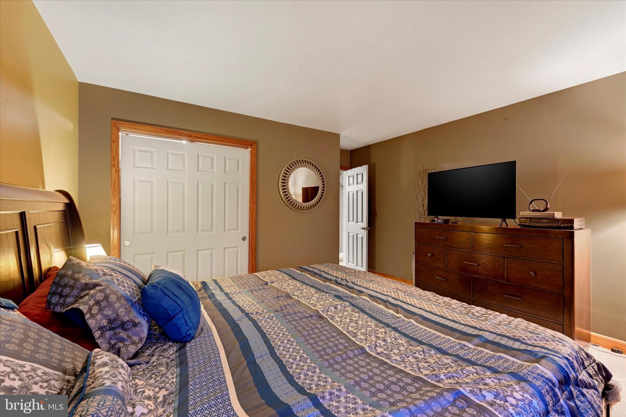 1813 Hanford Road Rosedale, MD 21237 - Photo 13 of 39 a bedroom with a bed and a flat screen tv
