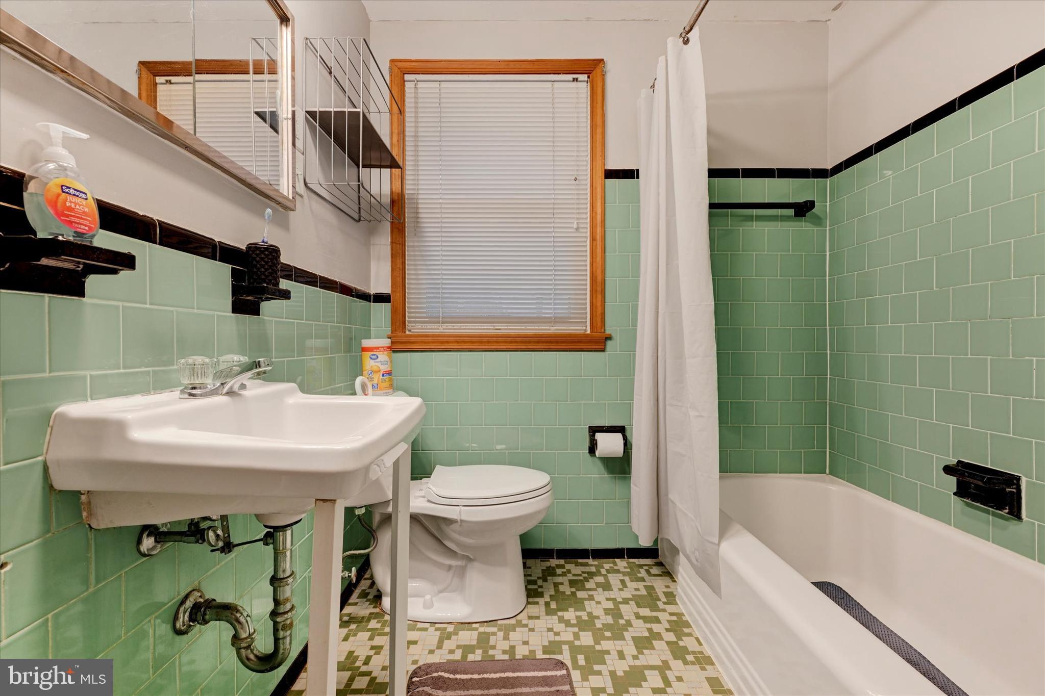 1813 Hanford Road Rosedale, MD 21237 - Photo 16 of 39 a bathroom with a sink a toilet and shower