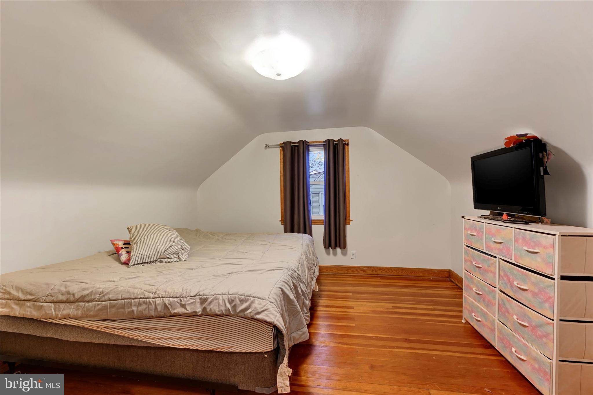 1813 Hanford Road Rosedale, MD 21237 - Photo 17 of 39 a bedroom with a bed and a flat screen tv