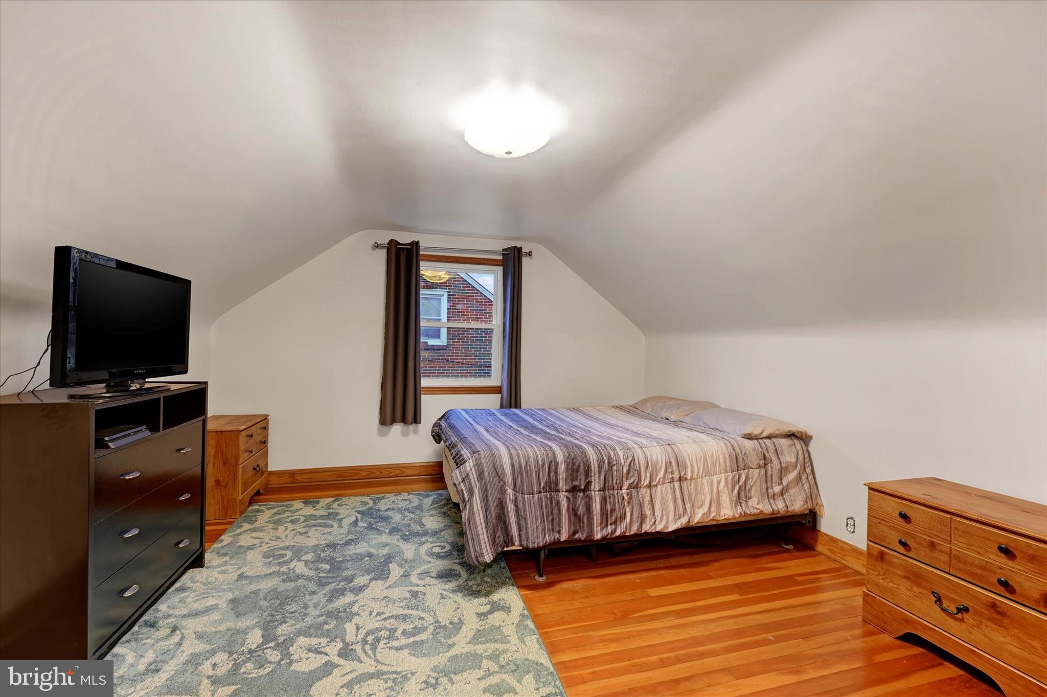 1813 Hanford Road Rosedale, MD 21237 - Photo 18 of 39 a living room with a bed furniture and a flat screen tv