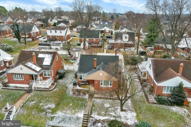 an aerial view of residential houses with yard