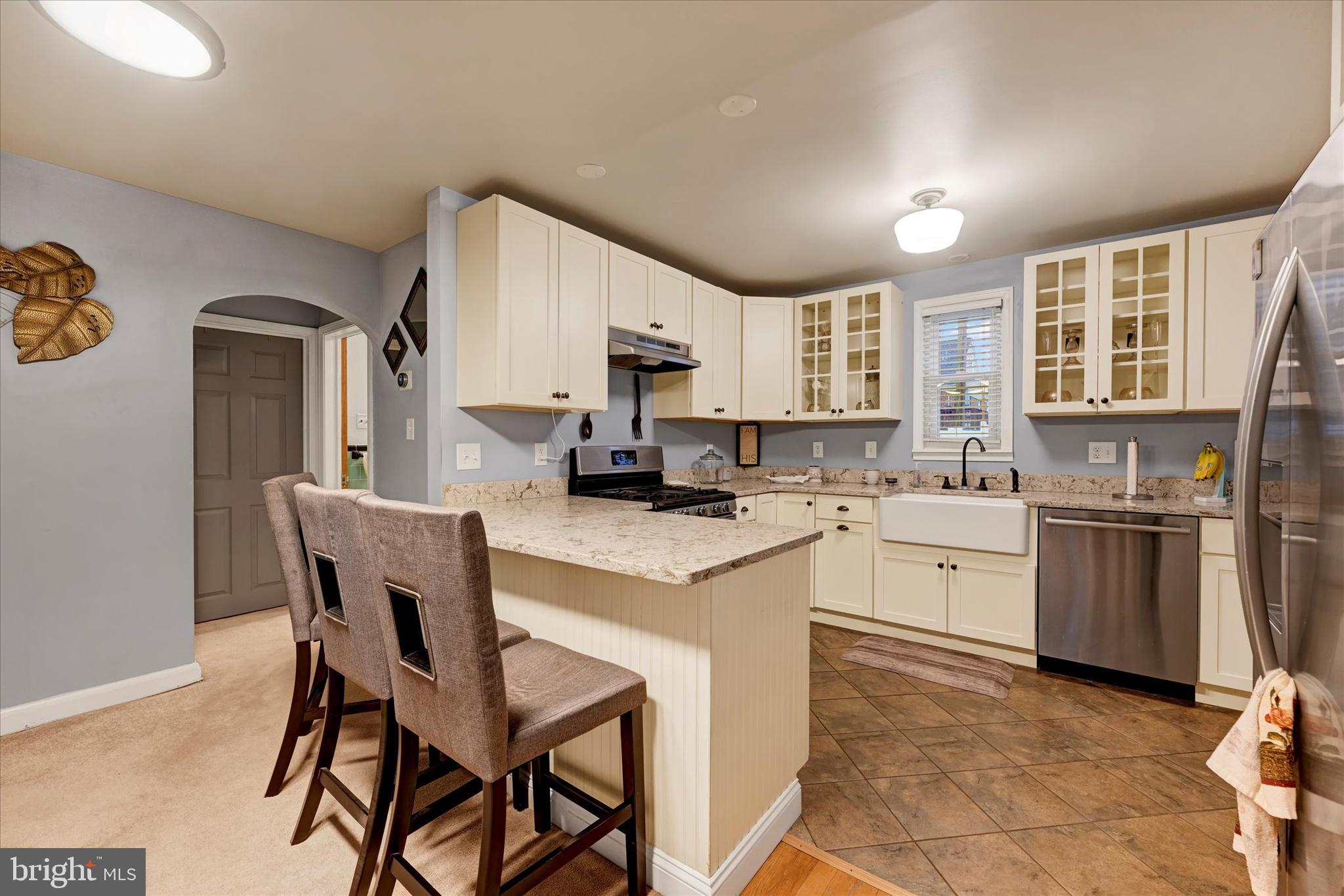 1813 Hanford Road Rosedale, MD 21237 - Photo 9 of 39 a kitchen with a stove cabinets and a refrigerator