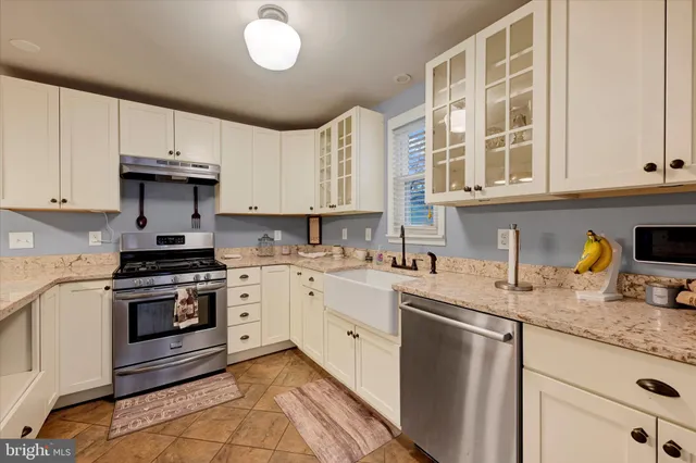 a kitchen with stainless steel appliances granite countertop a stove and a sink