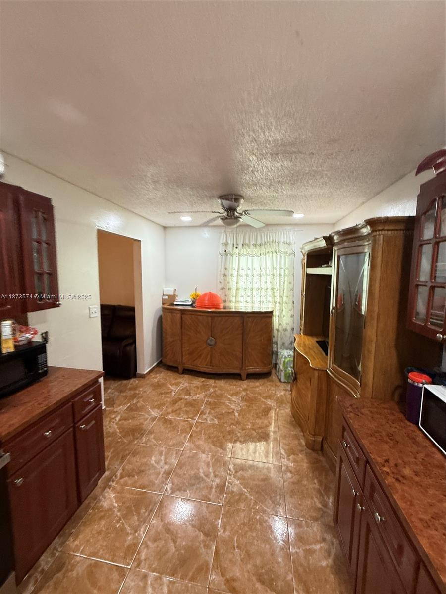 769 Southwest 8th Terrace Florida City, FL 33034 - Photo 13 of 25 a kitchen with granite countertop a refrigerator and a stove top oven
