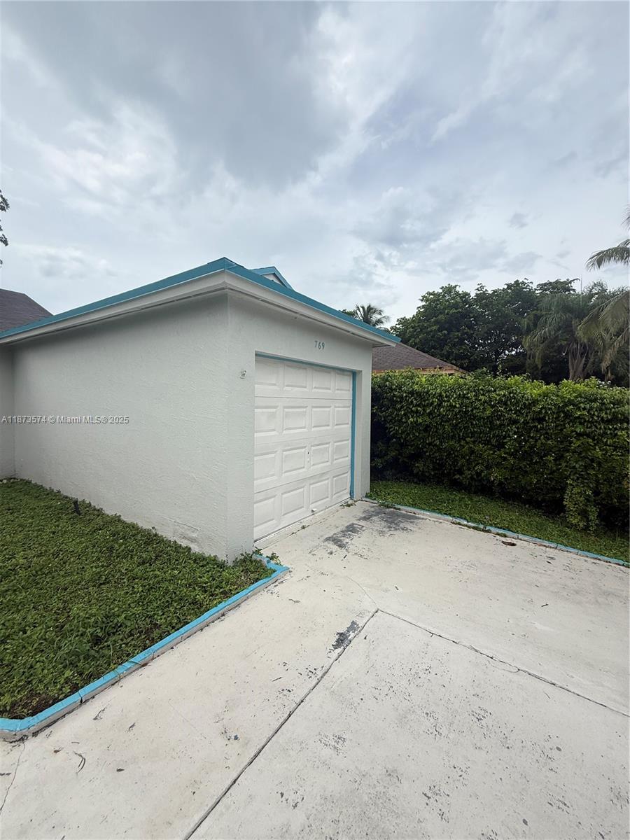 769 Southwest 8th Terrace Florida City, FL 33034 - Photo 2 of 25 a backyard of a house with lots of green space and garage