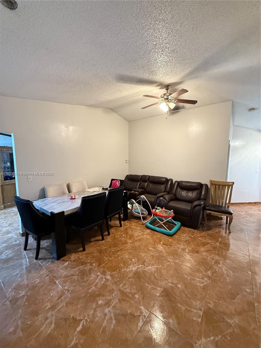 769 Southwest 8th Terrace Florida City, FL 33034 - Photo 5 of 25 a living room with furniture a ceiling fan and a rug