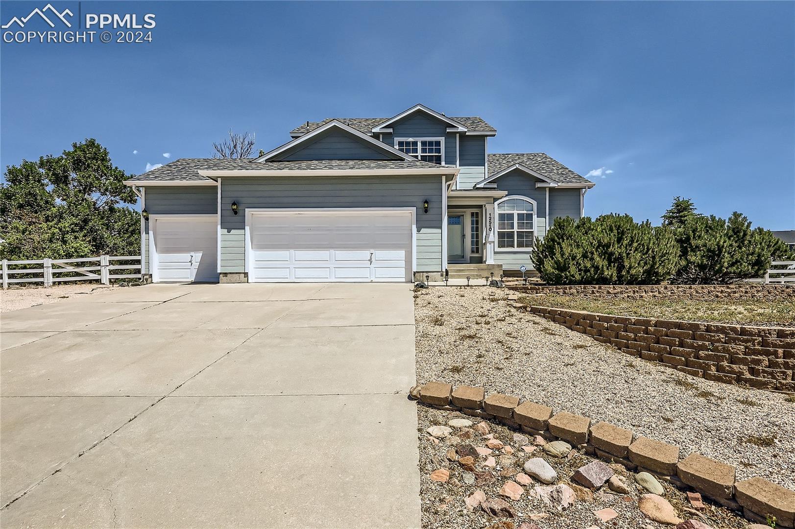 12510 Motley Road Peyton, CO 80831 - Photo 1 of 36 View of front facade featuring a garage