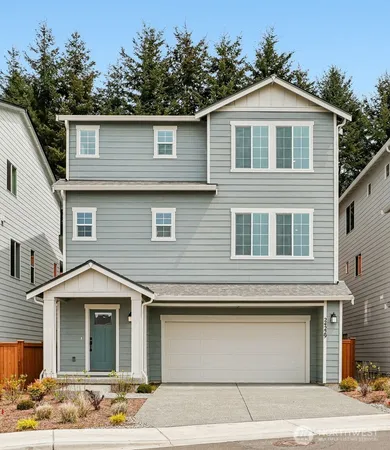 a front view of a house with a parking space