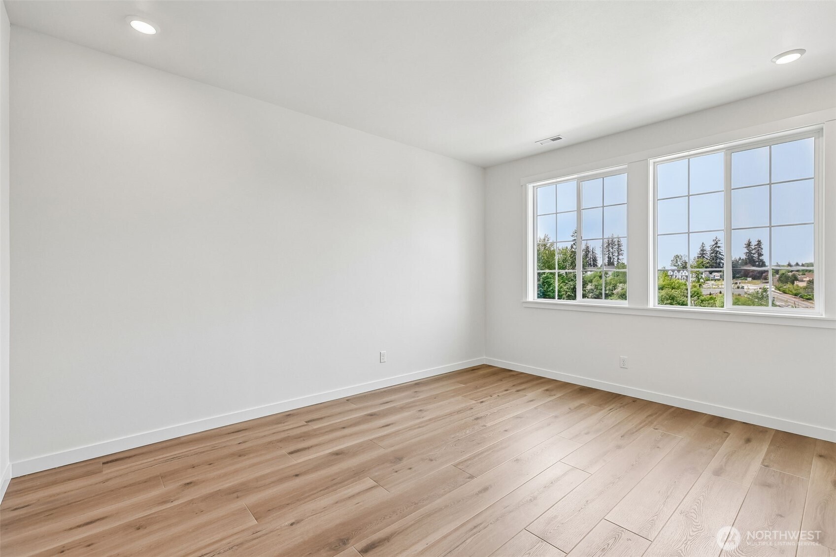 24229 13 Avenue Southeast, Unit CR27 Bothell, WA 98021 - Photo 17 of 40 an empty room with wooden floor and windows