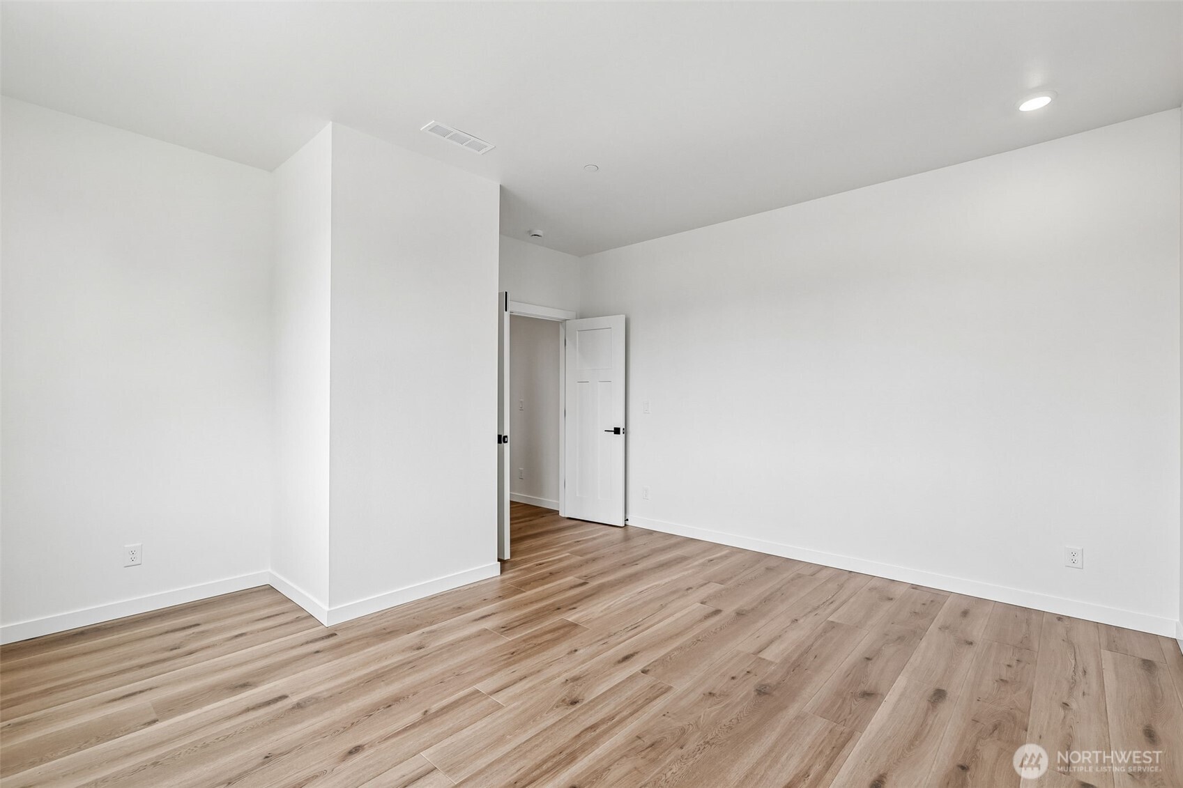 24229 13 Avenue Southeast, Unit CR27 Bothell, WA 98021 - Photo 18 of 40 a view of an empty room with wooden floor