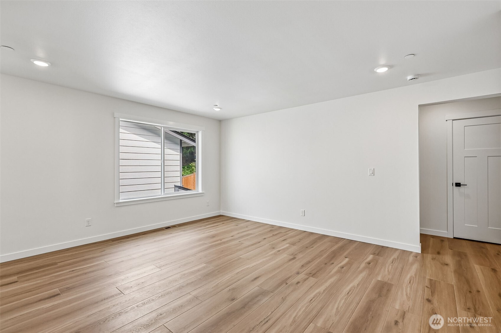 24229 13 Avenue Southeast, Unit CR27 Bothell, WA 98021 - Photo 30 of 40 a view of an empty room with wooden floor and a window