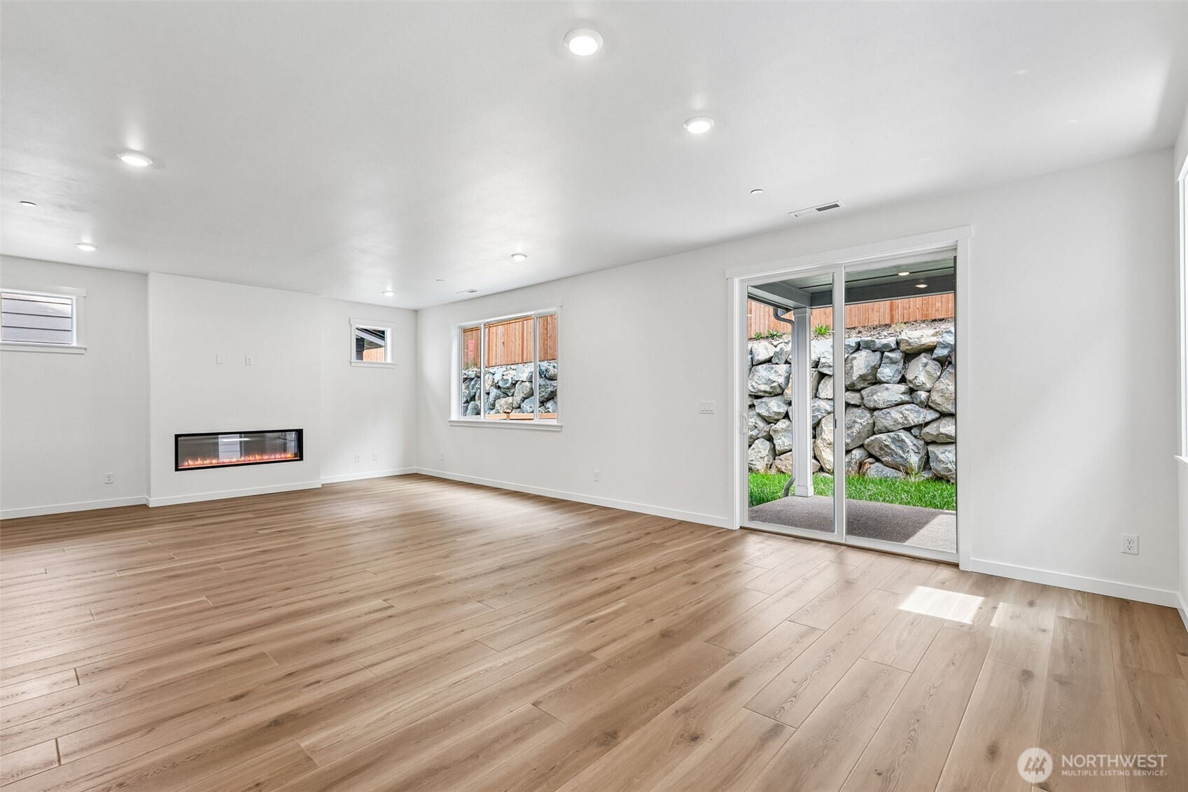 24229 13 Avenue Southeast, Unit CR27 Bothell, WA 98021 - Photo 8 of 40 an empty room with wooden floor and windows