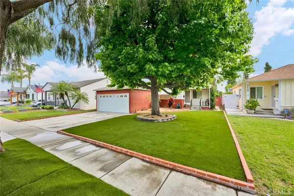 a view of yard with swimming pool and green space