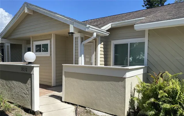 a front view of a house with outdoor seating space