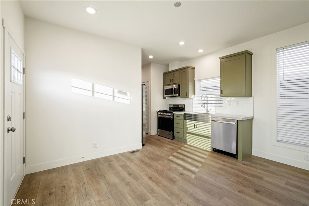 732 East Rte 66, Unit 7 Glendora, CA 91740 - Photo 4 of 15 a kitchen with a refrigerator and a stove top oven