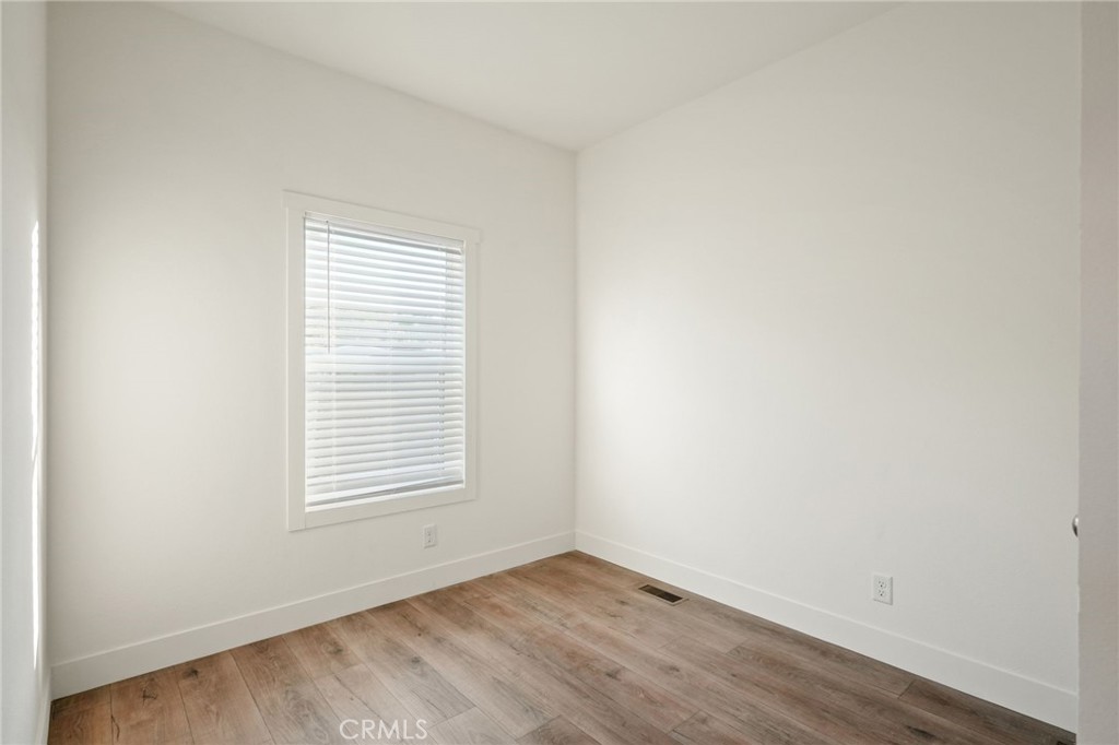 732 East Rte 66, Unit 7 Glendora, CA 91740 - Photo 9 of 15 an empty room with wooden floor and windows