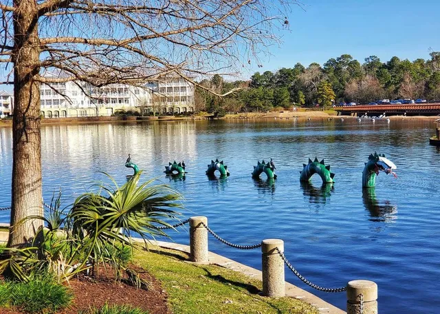 a view of a lake with houses in the back