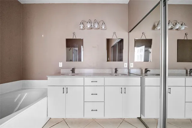 a bathroom with a double vanity sink mirror and
