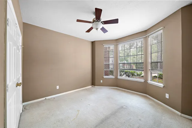 a view of room with window and ceiling fan