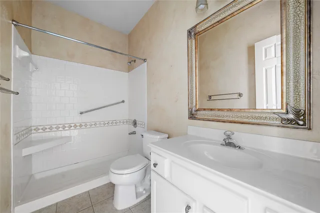 a bathroom with a sink a toilet and a shower