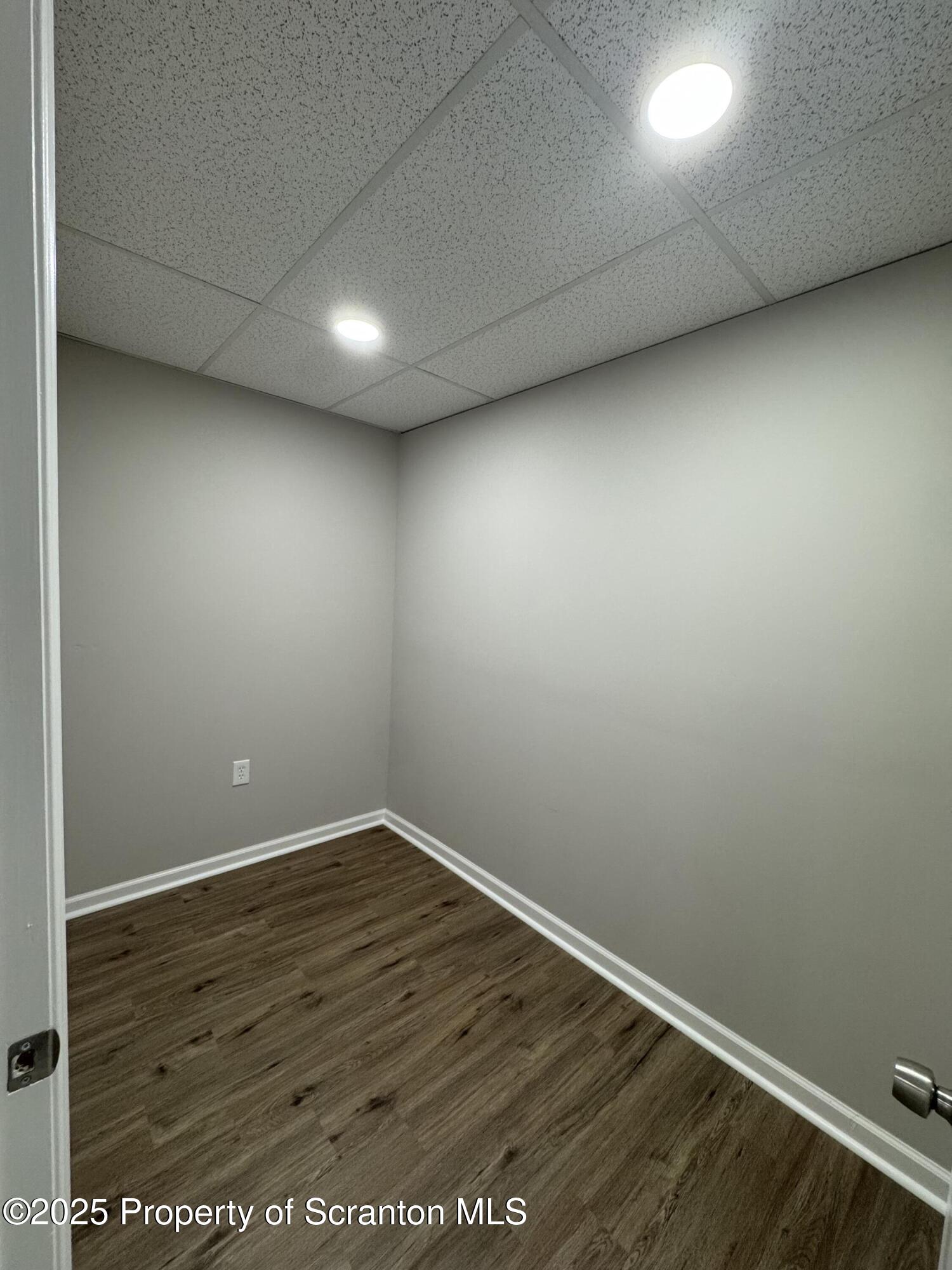 4 Kelly Street, Unit 8 Archbald, PA 18403 - Photo 13 of 16 an empty room with wooden floor and windows