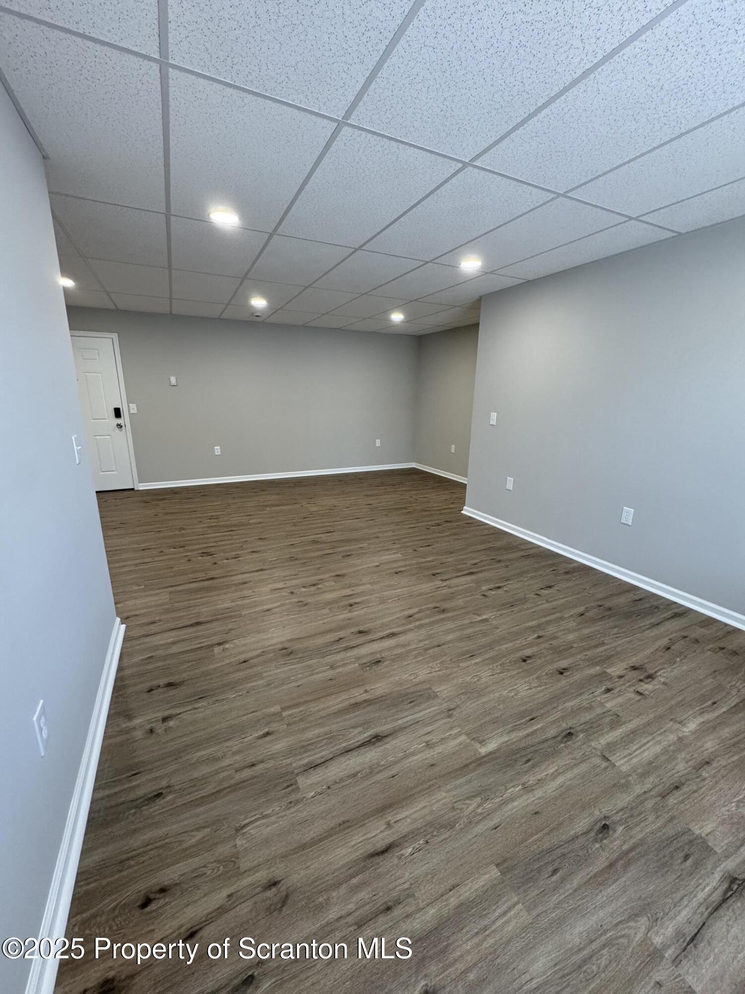 4 Kelly Street, Unit 8 Archbald, PA 18403 - Photo 8 of 16 an empty room with wooden floor