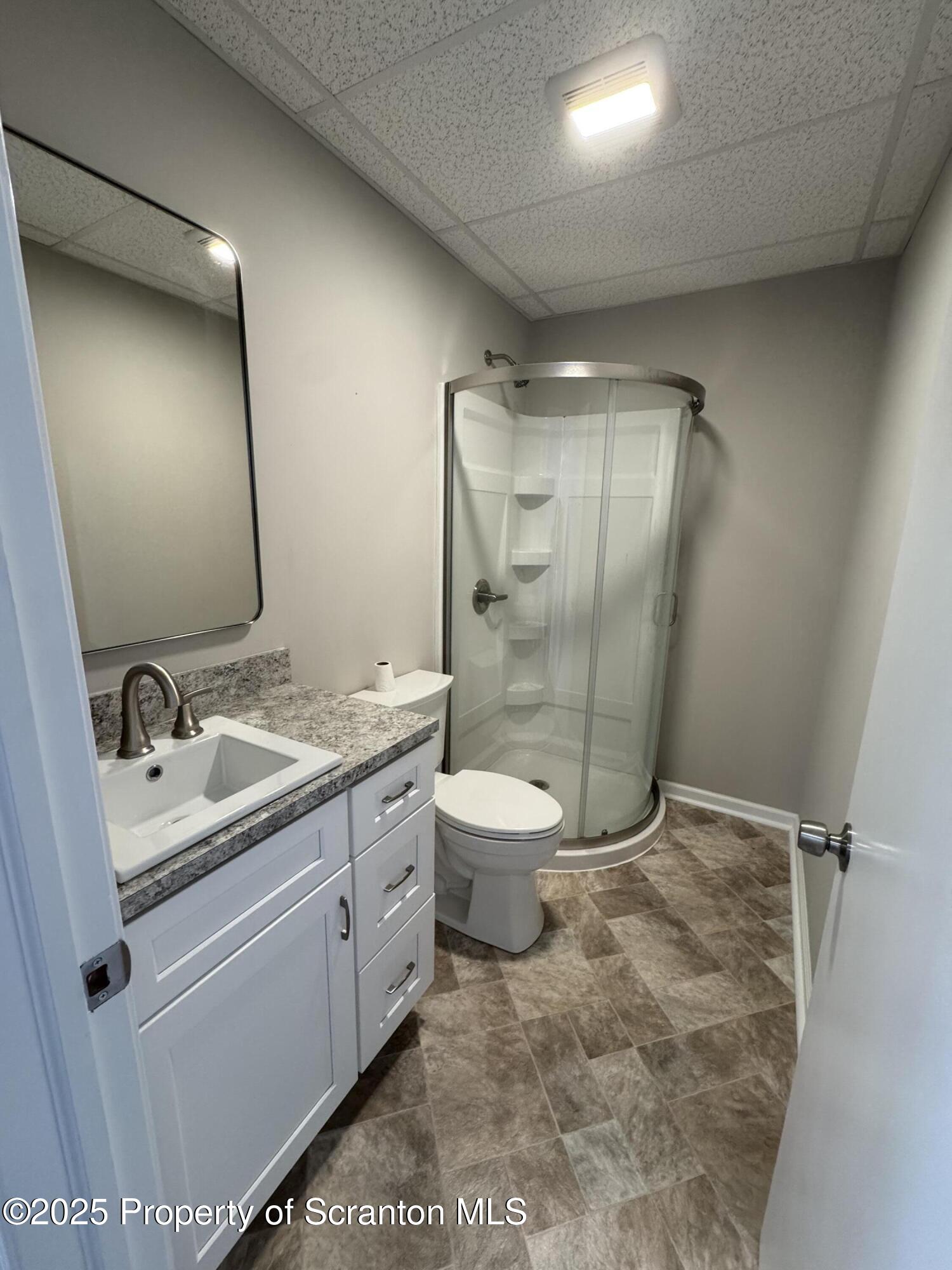 4 Kelly Street, Unit 8 Archbald, PA 18403 - Photo 9 of 16 a bathroom with a double vanity sink toilet and shower