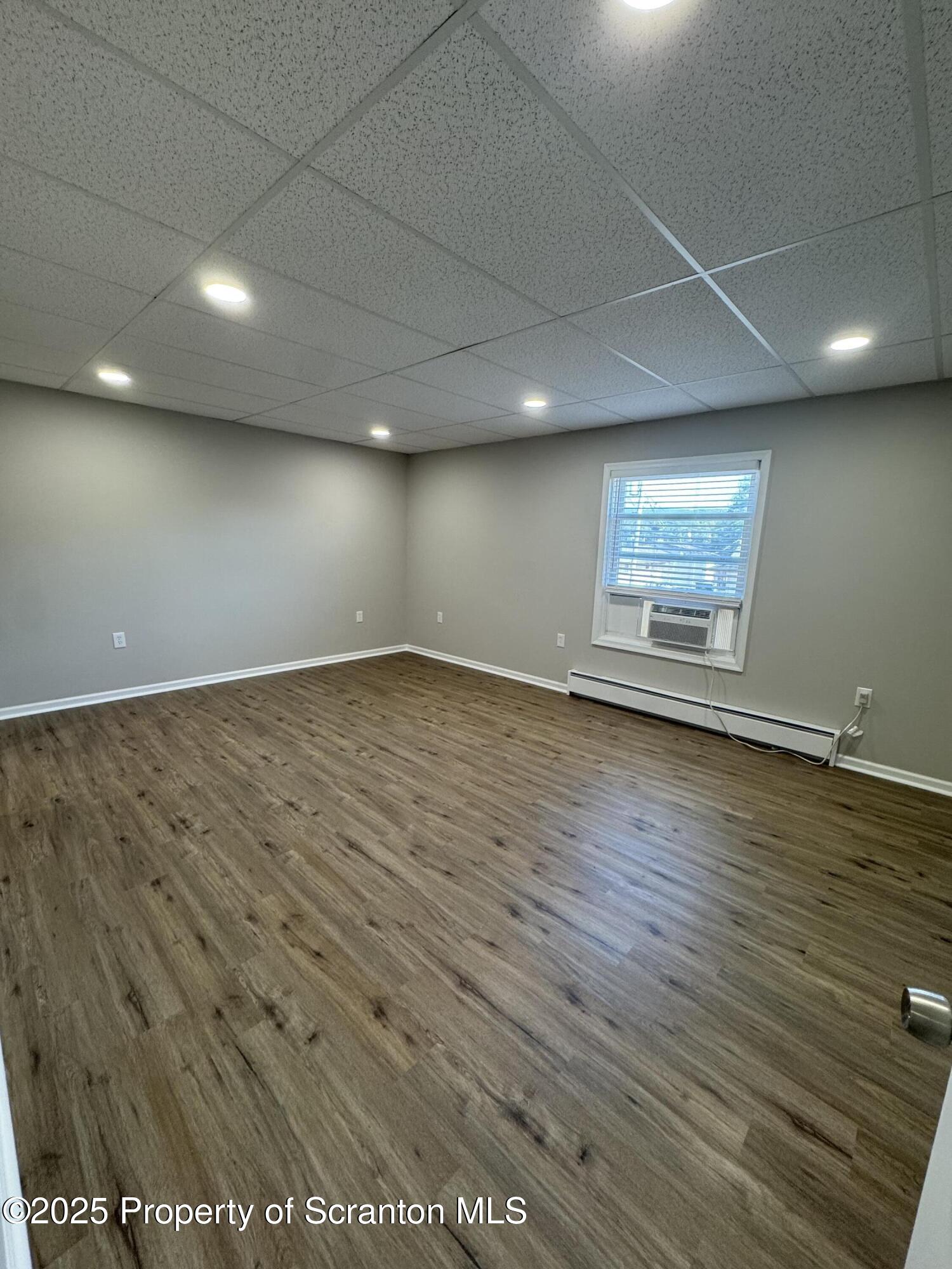 4 Kelly Street, Unit 8 Archbald, PA 18403 - Photo 10 of 16 an empty room with wooden floor and windows