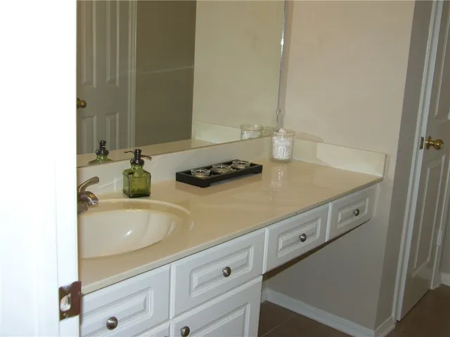 a view of a small space with wooden floor and a window