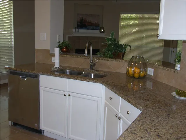 a kitchen with a sink and cabinets