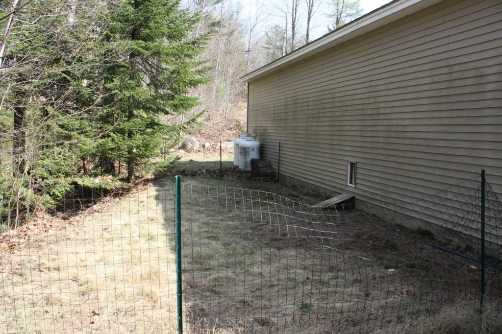 393 College Road Greene, ME 04236 - Photo 23 of 35 BACK OF GARAGE WITH DOG DOOR AND...