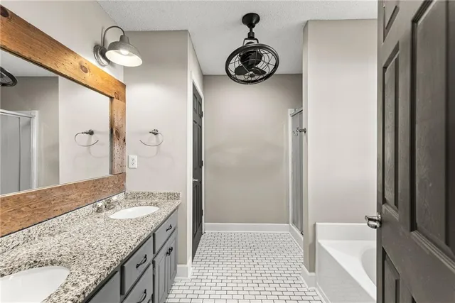 a bathroom with a granite countertop sink a toilet and shower