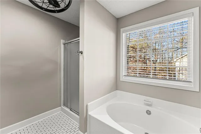 a bathroom with a bathtub and a window
