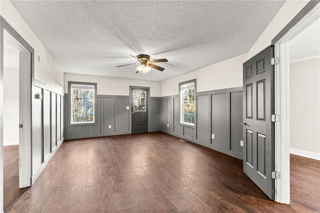 a view of an empty room with wooden floor