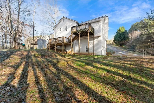 a view of a house with a yard and sitting area