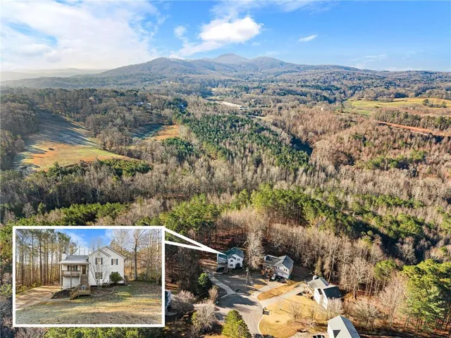 an aerial view of a house with a yard