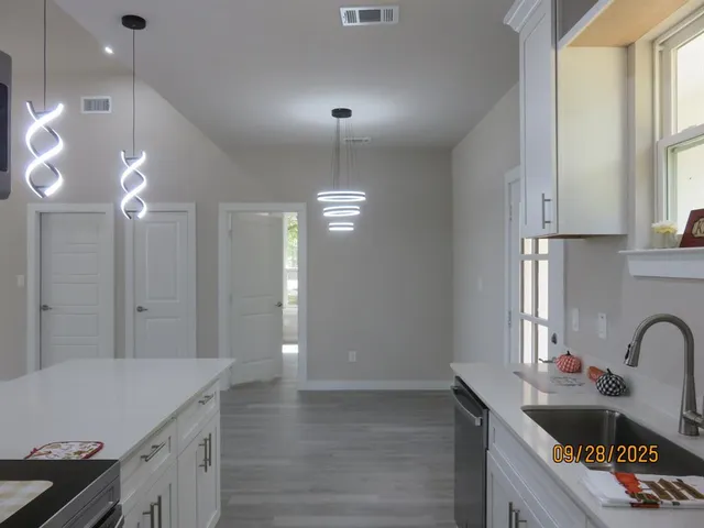 a kitchen that has a lot of cabinets in it