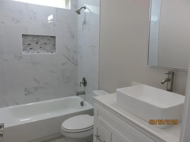 a bathroom with a sink a toilet and a bathtub