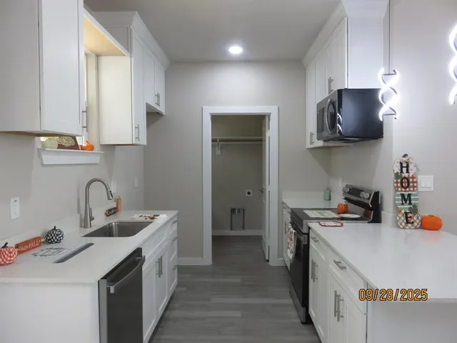 a kitchen with stainless steel appliances a sink stove and refrigerator